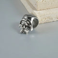 Stainless steel hollow geometric earrings combining a skull with a Buddha head motif.