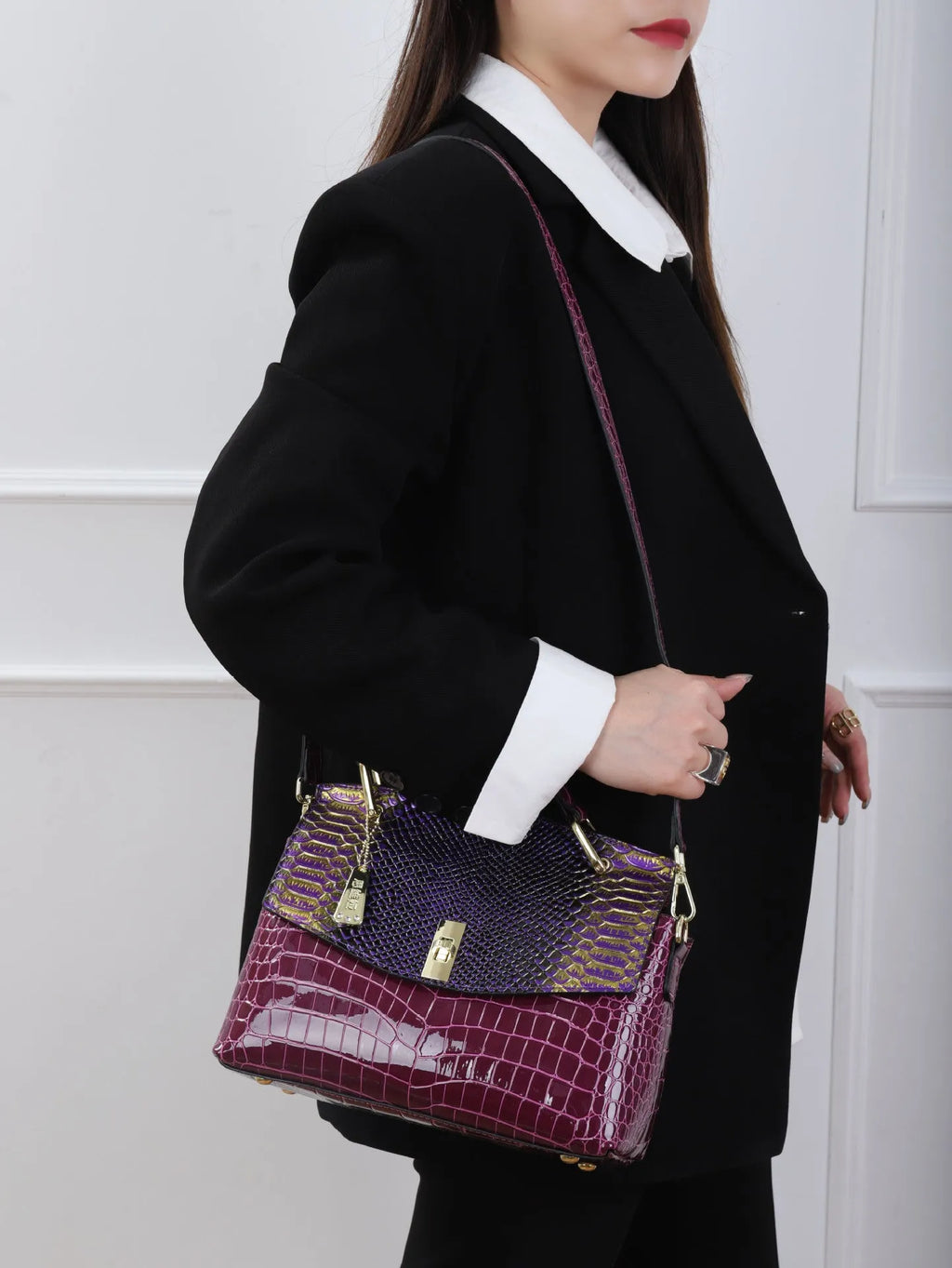 Colourful women's crossbody bag with snake and crocodile pattern, showing double straps and horizontal square shape.