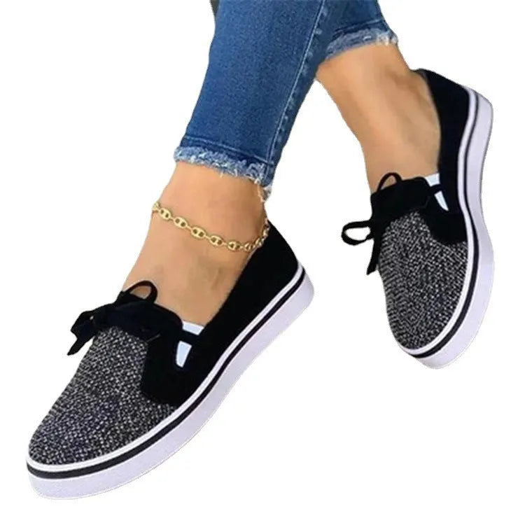 White canvas lace-up flat shoes for women with cross strap design and round toe