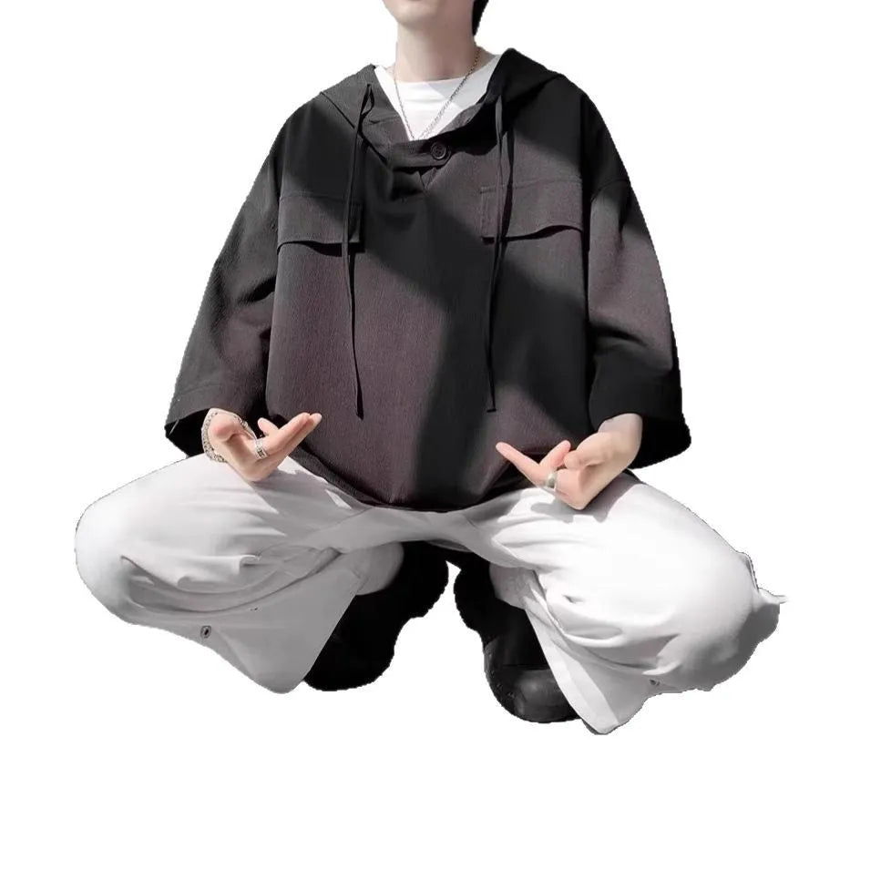 Men's grey hooded short sleeve t-shirt showing loose fit pullover design