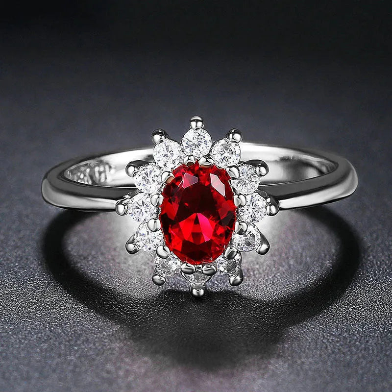 Women's floral copper ring with a blue moissanite centre stone on a model's finger.