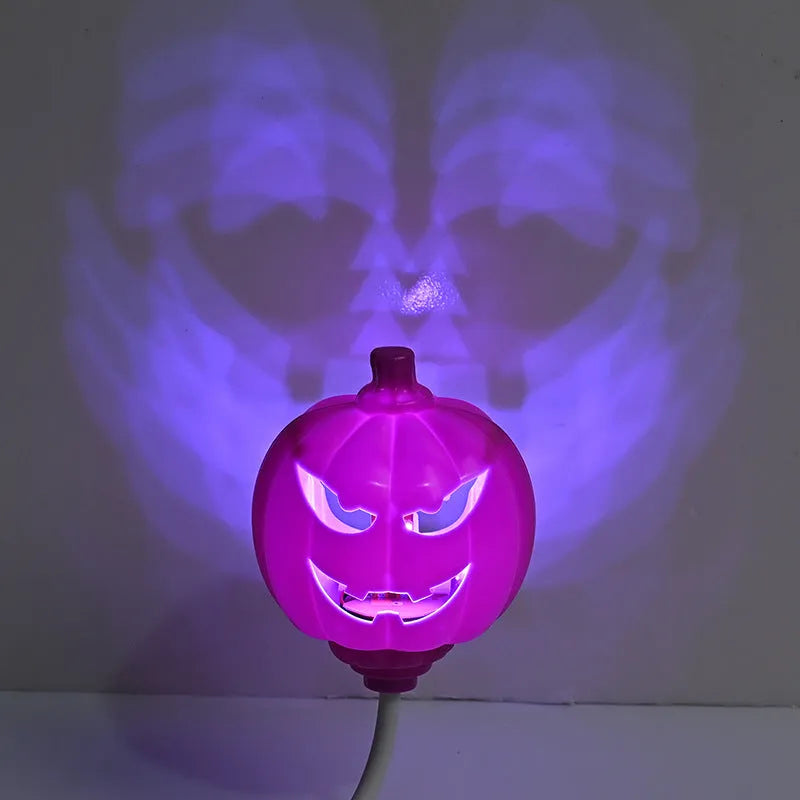Plastic pumpkin-shaped decorative lamp with a USB cable, glowing either yellow or purple.