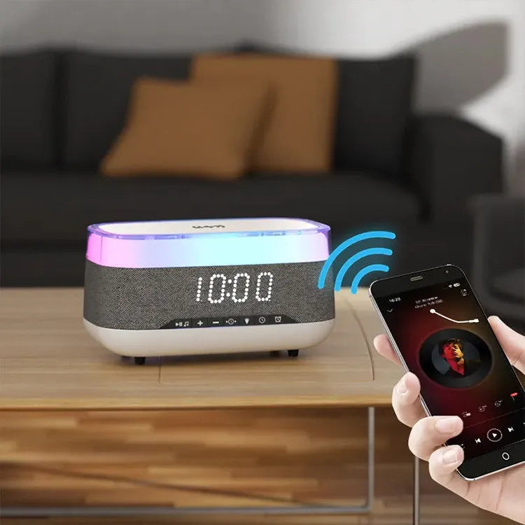 White multifunctional alarm clock unit with Bluetooth speaker and wireless charging pad.