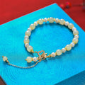 Hetian jade bracelet with gold electroplated alloy clasp and round pearl pendant
