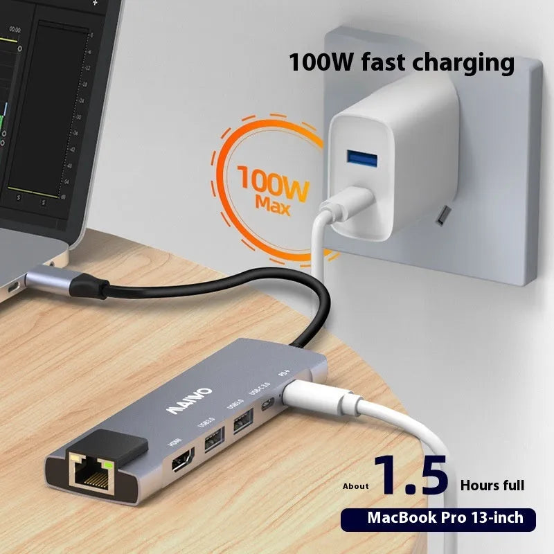 Steam Deck six-in-one USB-C docking station with aluminium shell, showing HDMI, USB 3.0, and RJ45 Ethernet ports.