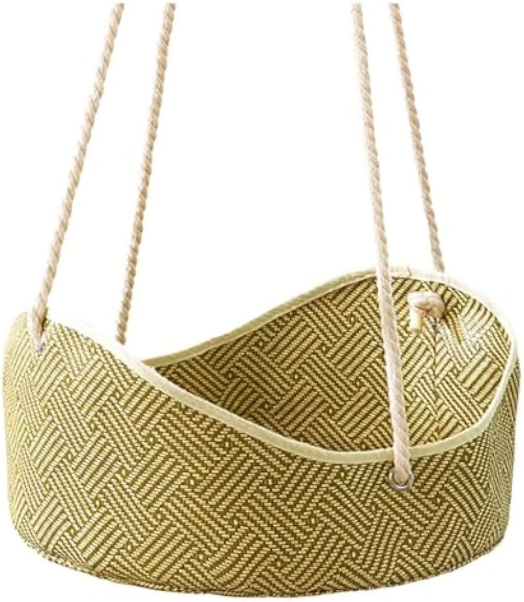 Green woven rattan cat hammock with metal hooks, hanging on a white shelf with a cat resting.