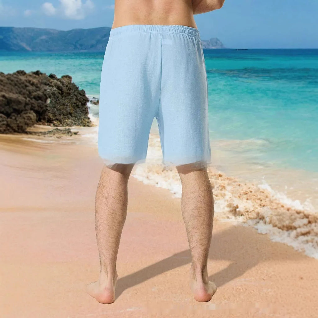 Man wearing blue colour block digital print casual shorts with a lace-up drawstring waist.