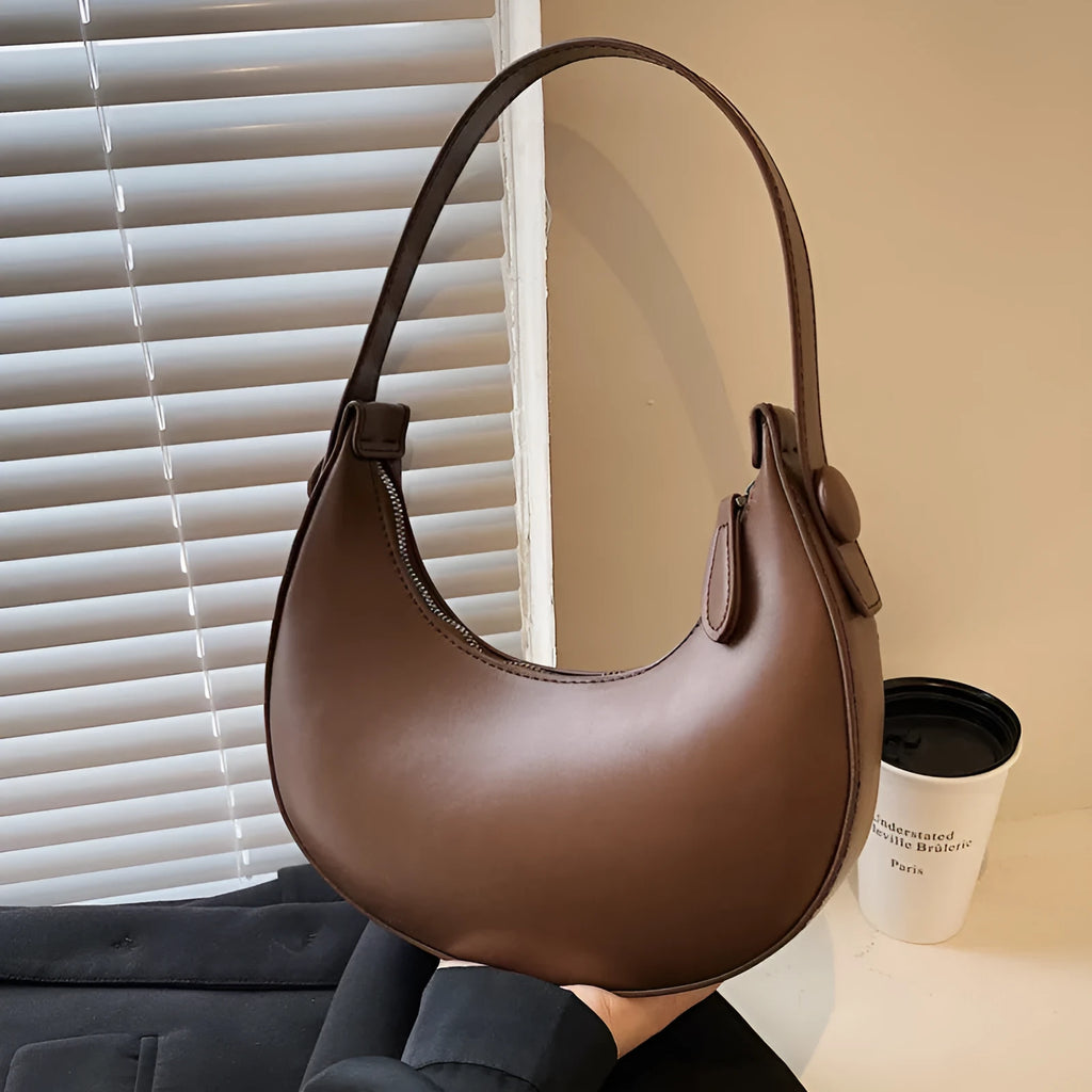 Women's retro brown PU dumpling shape shoulder bag with a front pocket shown.