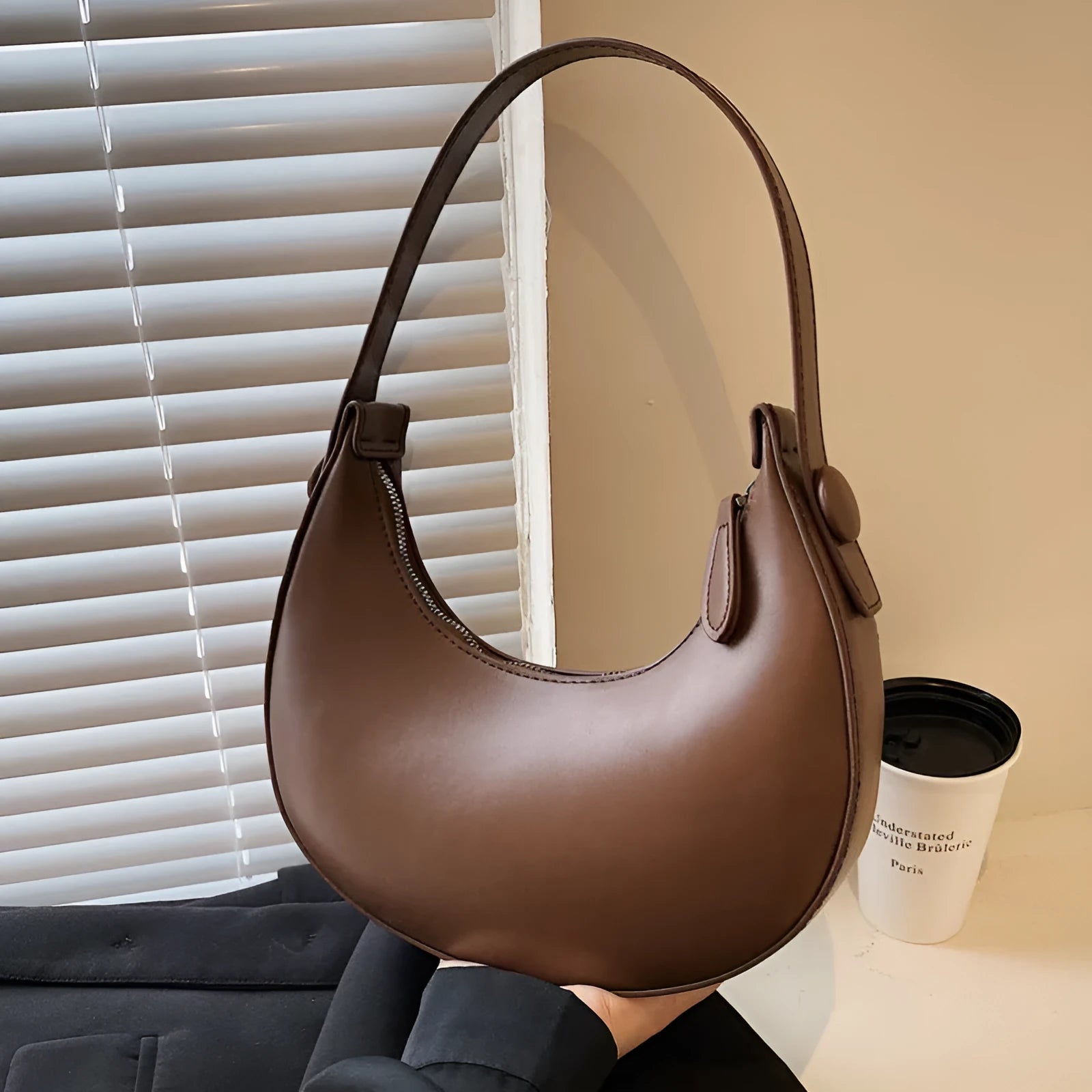 Women's retro brown PU dumpling shape shoulder bag with a front pocket shown.