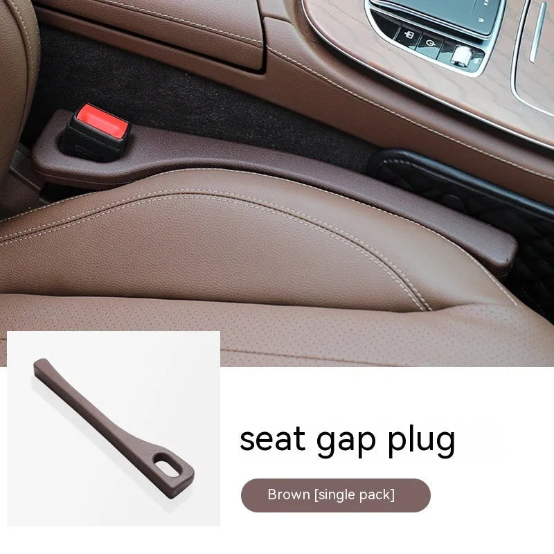 Car seat gap filler strip in polyurethane material shown installed between vehicle seat and centre console
