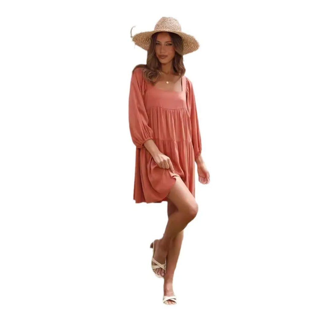 Girl in an orange red backless dress with a square collar and puff sleeves, showcasing the A-line skirt.