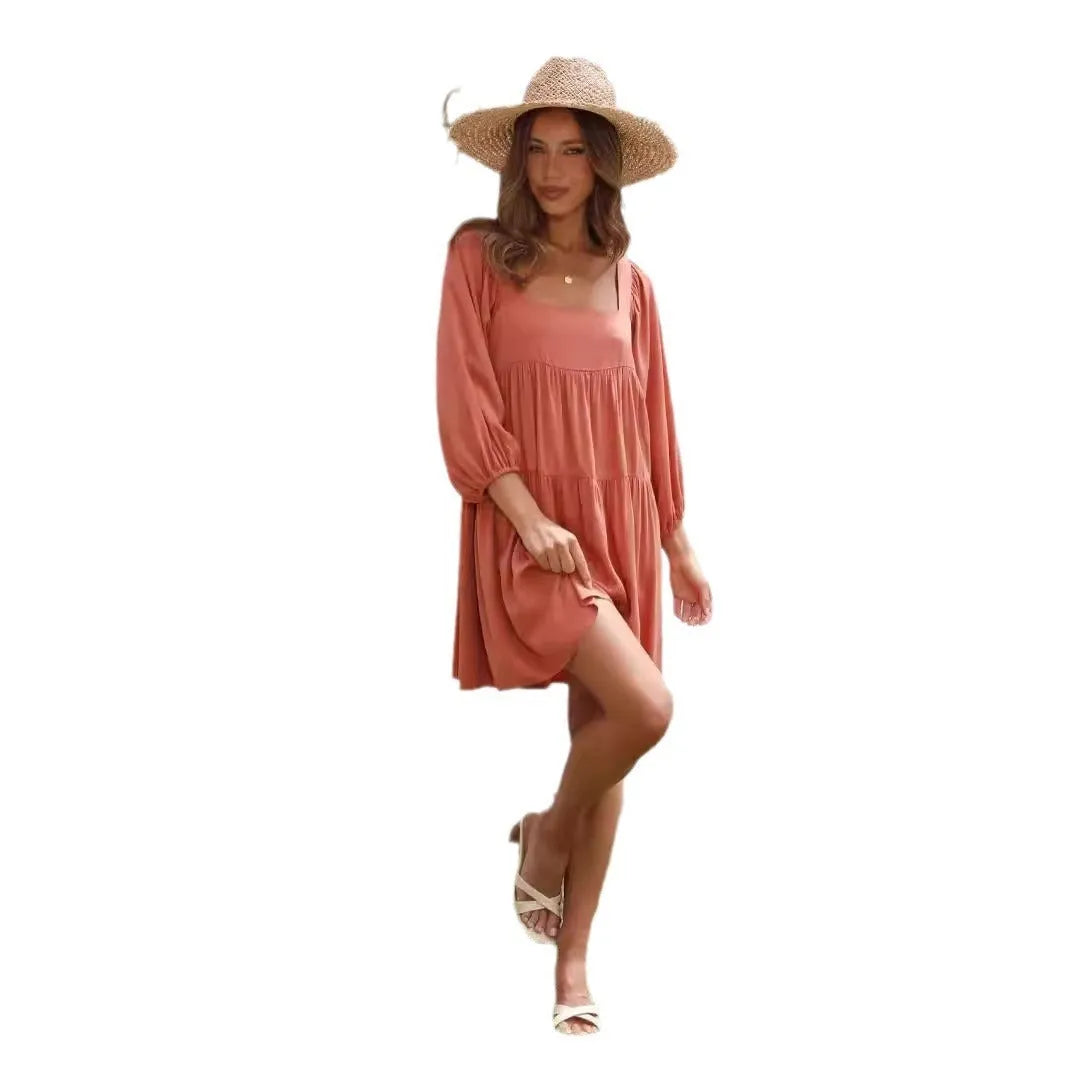 Girl in an orange red backless dress with a square collar and puff sleeves, showcasing the A-line skirt.