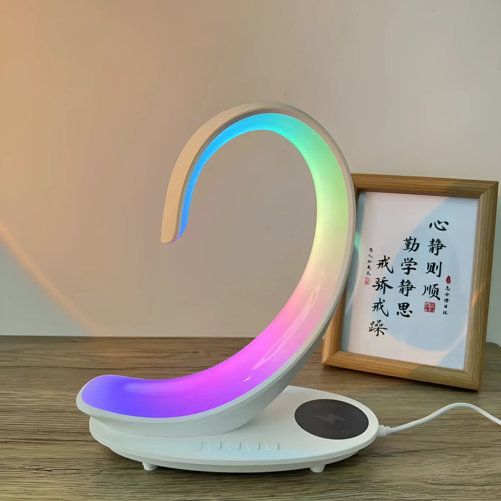White swan-shaped desk lamp with wireless charging pad and Bluetooth speaker providing colourful ambient lighting