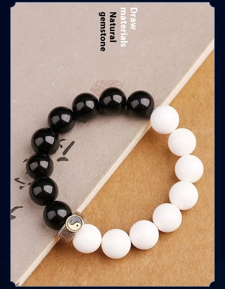 Black and white woven Taiji and Mantra bracelet on obsidian beads.