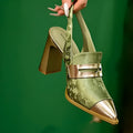 Women's black high heel sandals with chunky heel, pointed toe, and an elastic ankle strap.