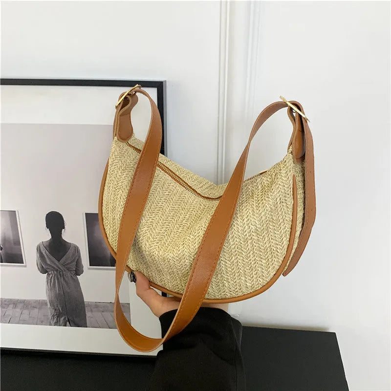 Women's woven straw crossbody bag showing textured surface with phone and file compartments inside