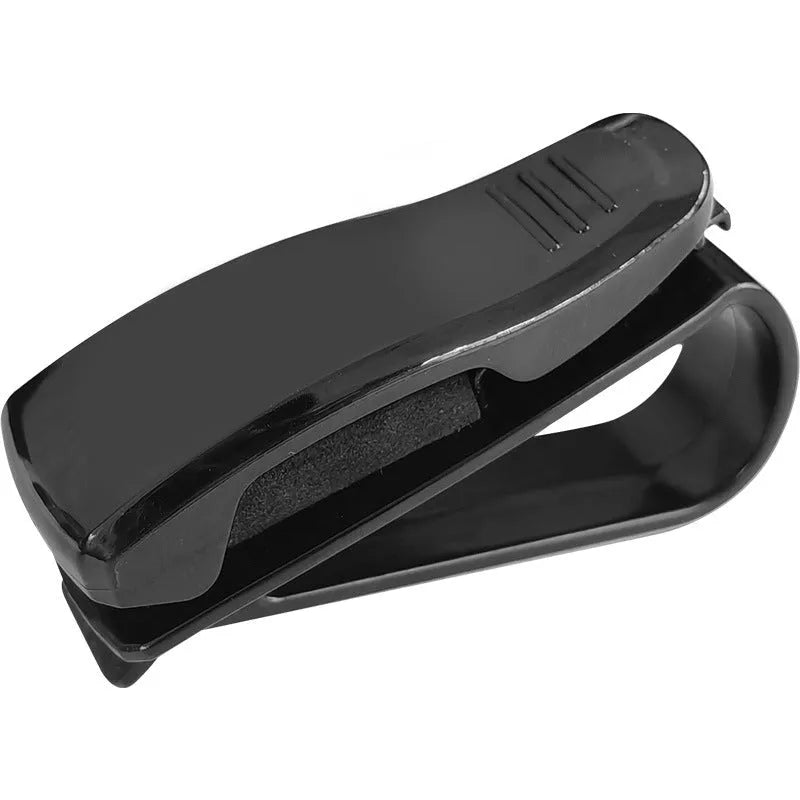 Black plastic clip for car sunshade to hold sunglasses and tickets.