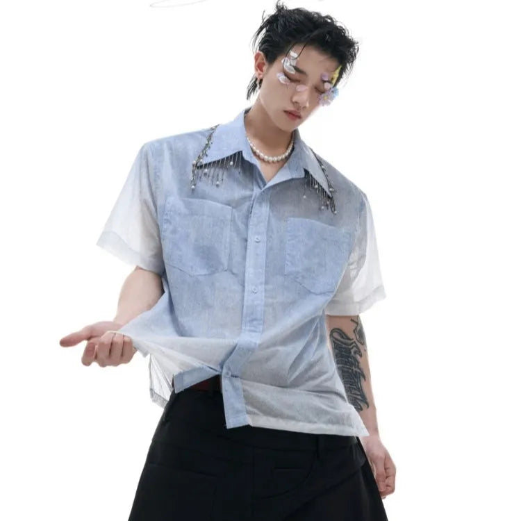 A blue and white gradient loose short-sleeve shirt on a hanger.