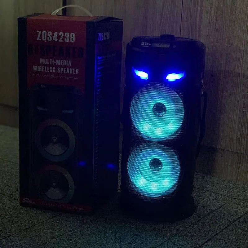 Black portable Bluetooth speaker with colourful dual horns, showing front panel with controls.