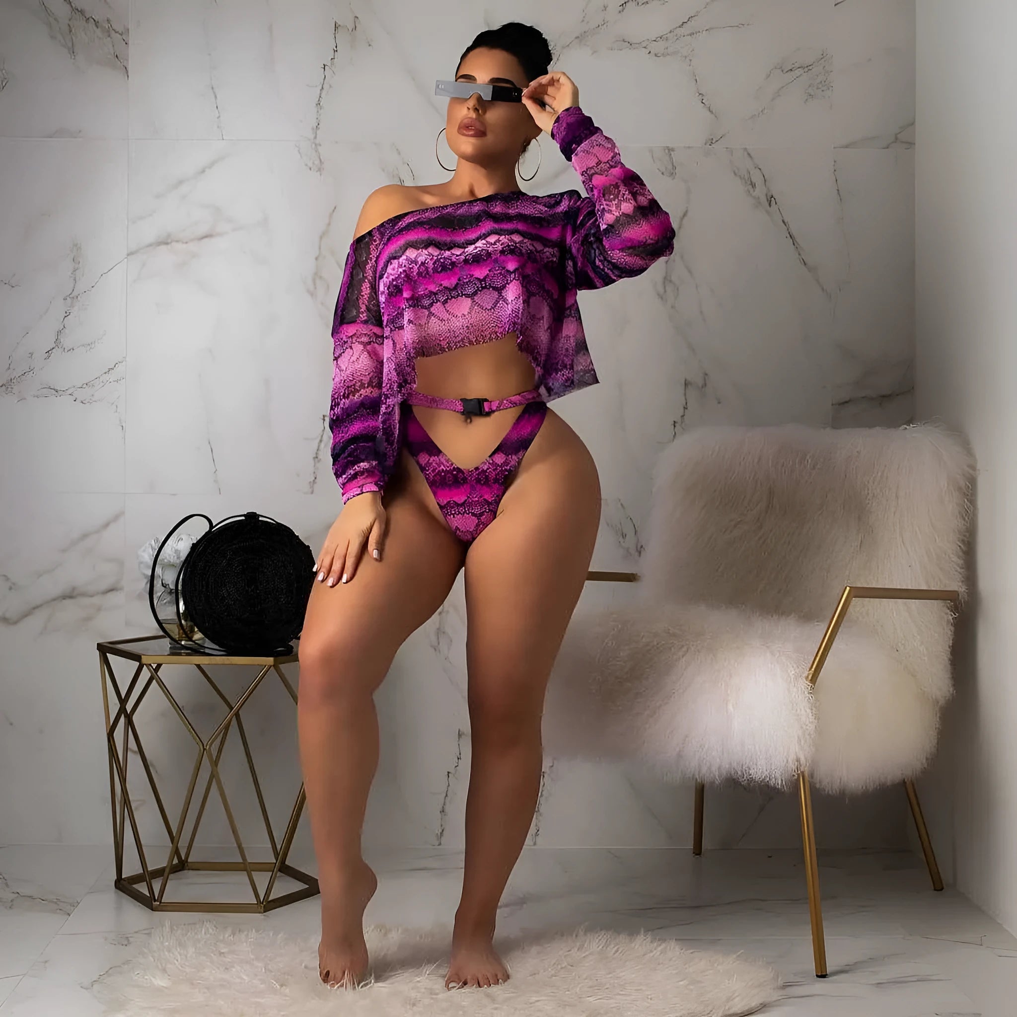 Women's purple snakeskin print bikini set with sleeveless top and shorts on a mannequin.