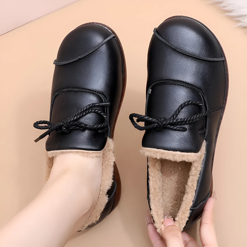Black flat non-slip slip-on fleece-lined warm shoes with microfiber upper and round toe
