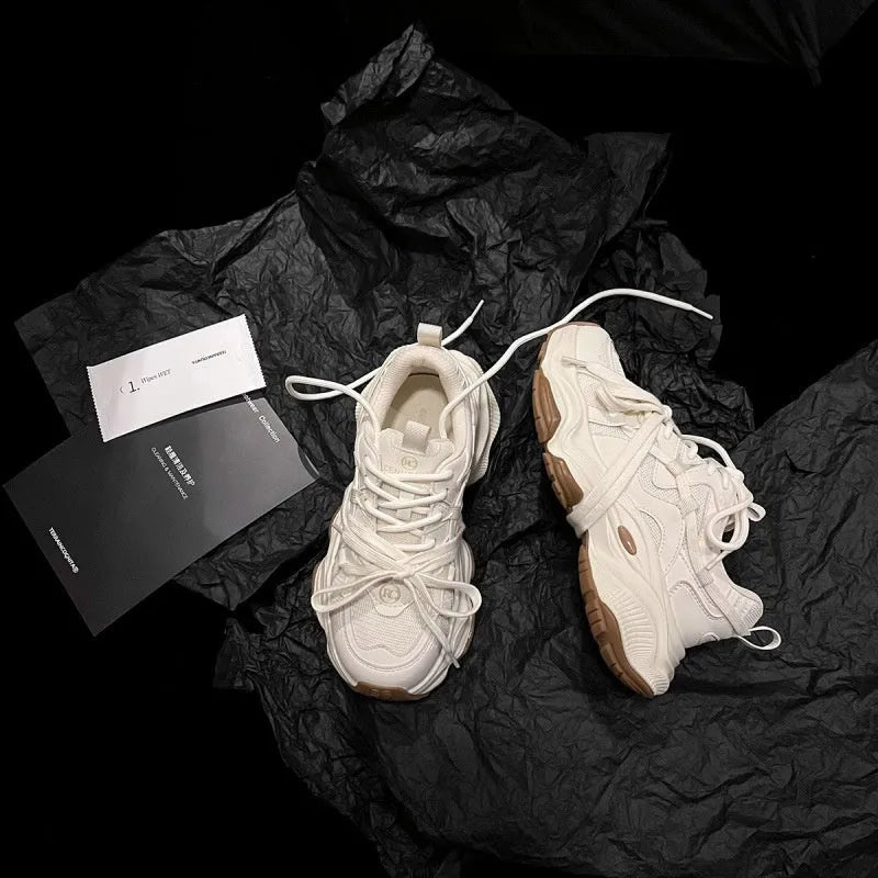 Women's beige platform sneaker with round toe and lace-up front on a white background.