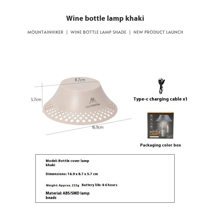 Beige and grey wine bottle-shaped camping lantern with USB-C port on a wooden table.
