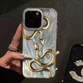 Gold snake design hard PC phone case for iPhone 16 Plus with white base and cartoon style