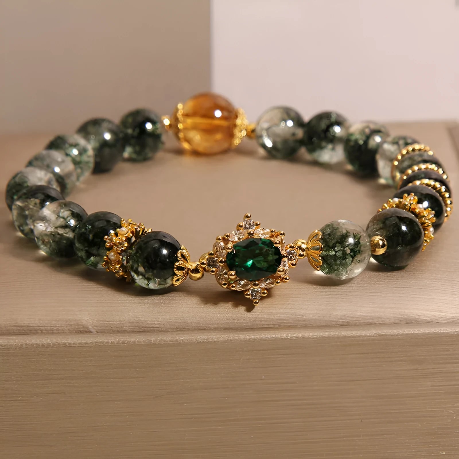 Women's crystal bracelet with gold rutilated quartz, green phantom quartz, and ruby quartz gemstones