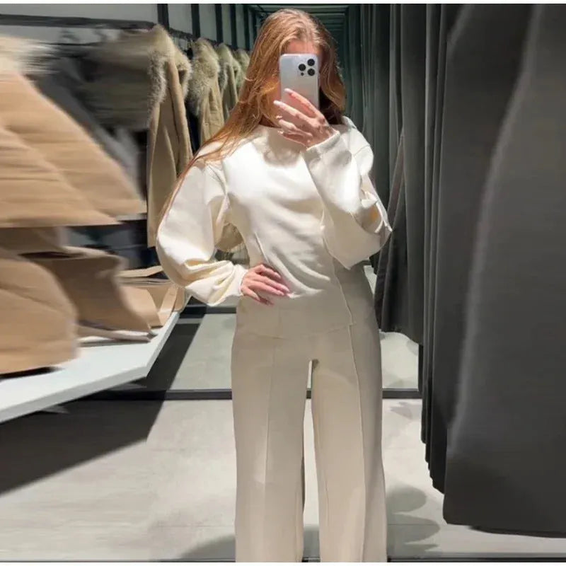 Women's long sleeve polar fleece suit set in apricot colour, showing O-neck top and wide-leg trousers.