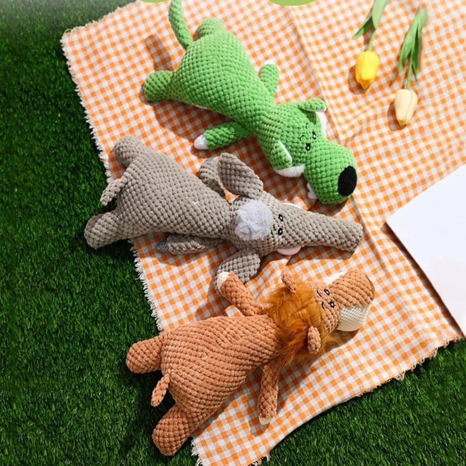 Green corn kernel shaped plush dog toy with a squeaker for interactive chewing and teeth cleaning
