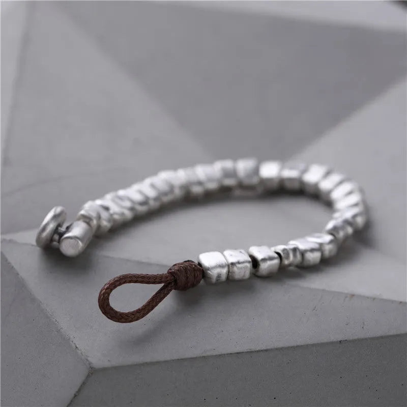 Handmade women's bracelet with silver squares and wooden beads on elastic cord