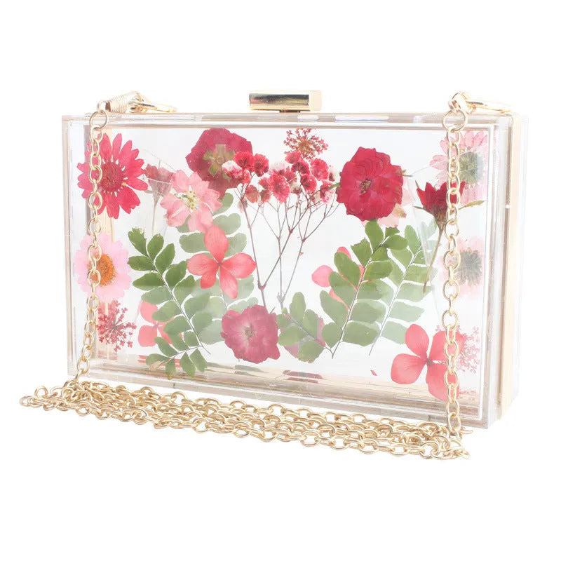 Acrylic transparent flower shoulder messenger bag with hard outer, horizontal square shape, O-shaped necklace, shown in blue.