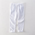 Men's straight leg linen trousers in light grey colour, showing mid waist and tailored fit.