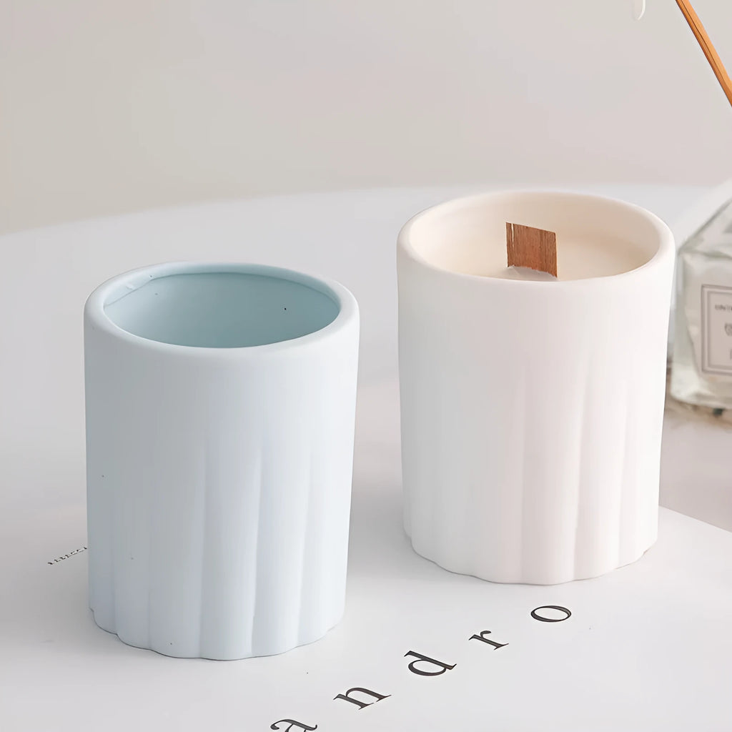 Ceramic candlestick with minimalist relief pattern on a dining table