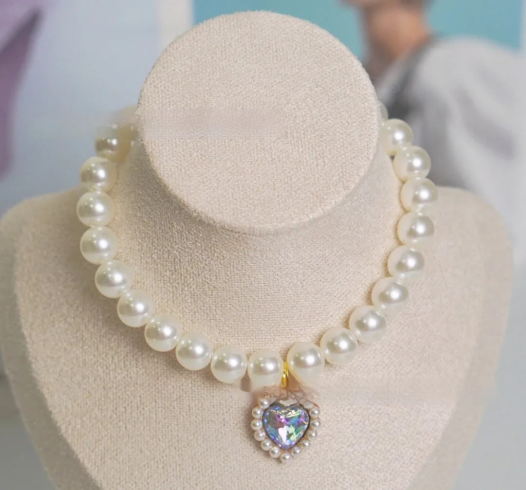 Cat collar with plastic heart charm in blue, shown alongside pink, green, purple, transparent and sapphire blue colour options