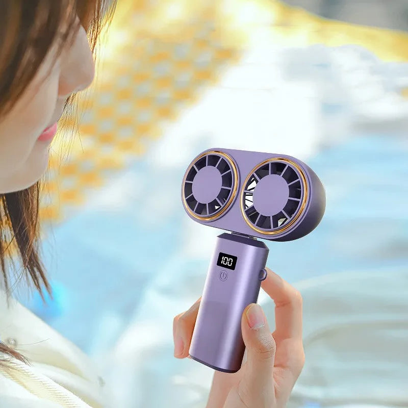 Dark blue foldable USB rechargeable handheld mini fan showing digital display screen and five blades.