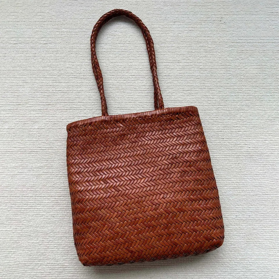 Brown handmade woven leather tote bag with a front pocket and polyester lining.