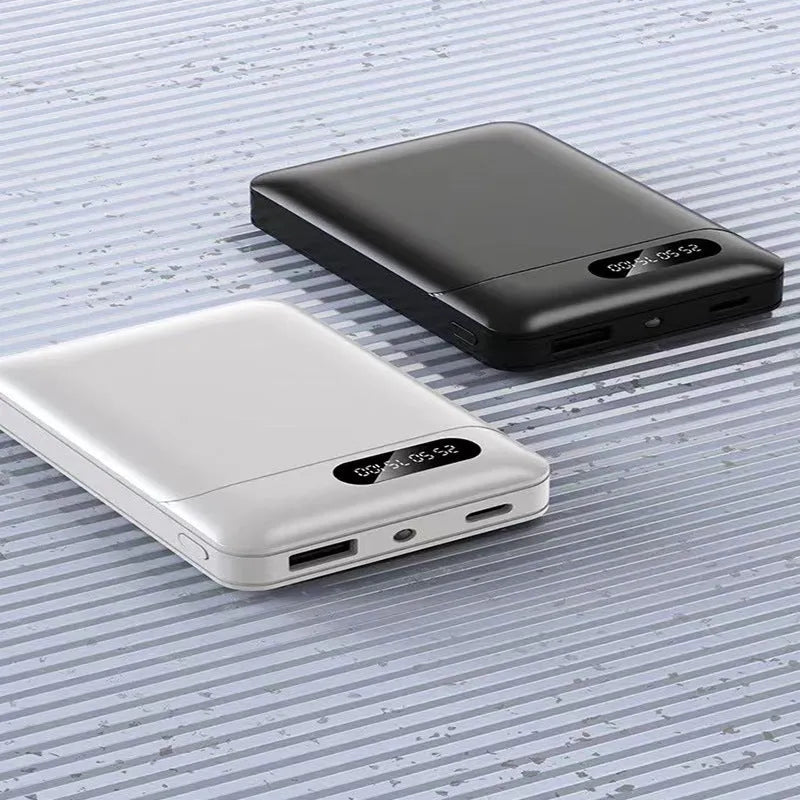 Black or white portable power bank with dual USB ports showing capacity options
