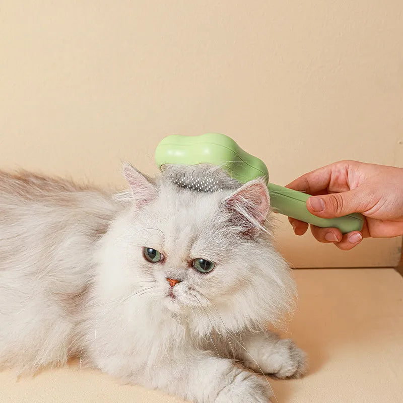 Green self-cleaning cat comb with four stainless steel needles measuring 20cm long