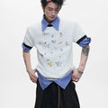 Men's blue loose fit short sleeve shirt with a cartoon print design on the front.