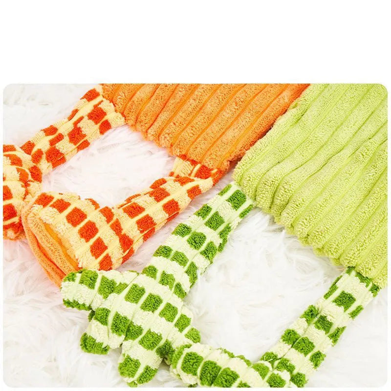 Orange and green plush dog toy with squeaker for aggressive chewers