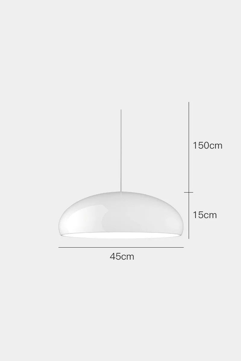 Modern Danish orange iron pendant lamp with adjustable cable over a restaurant dining table.