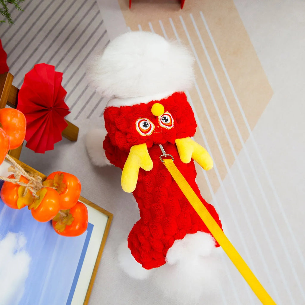 Red velvet pet jacket with cartoon dragon design for dogs and cats on a hanger