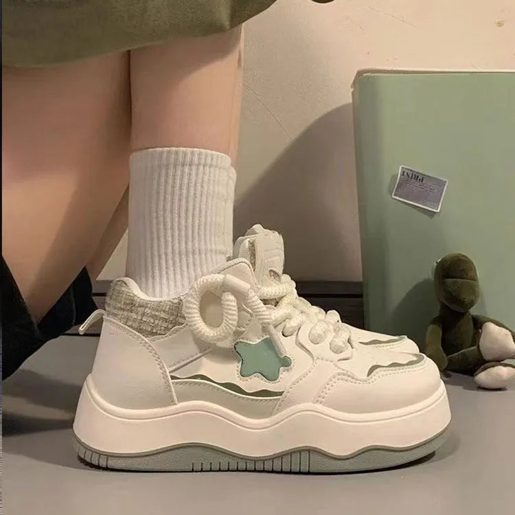 Women's green platform sneakers with lace-up front and round toe design on rubber sole