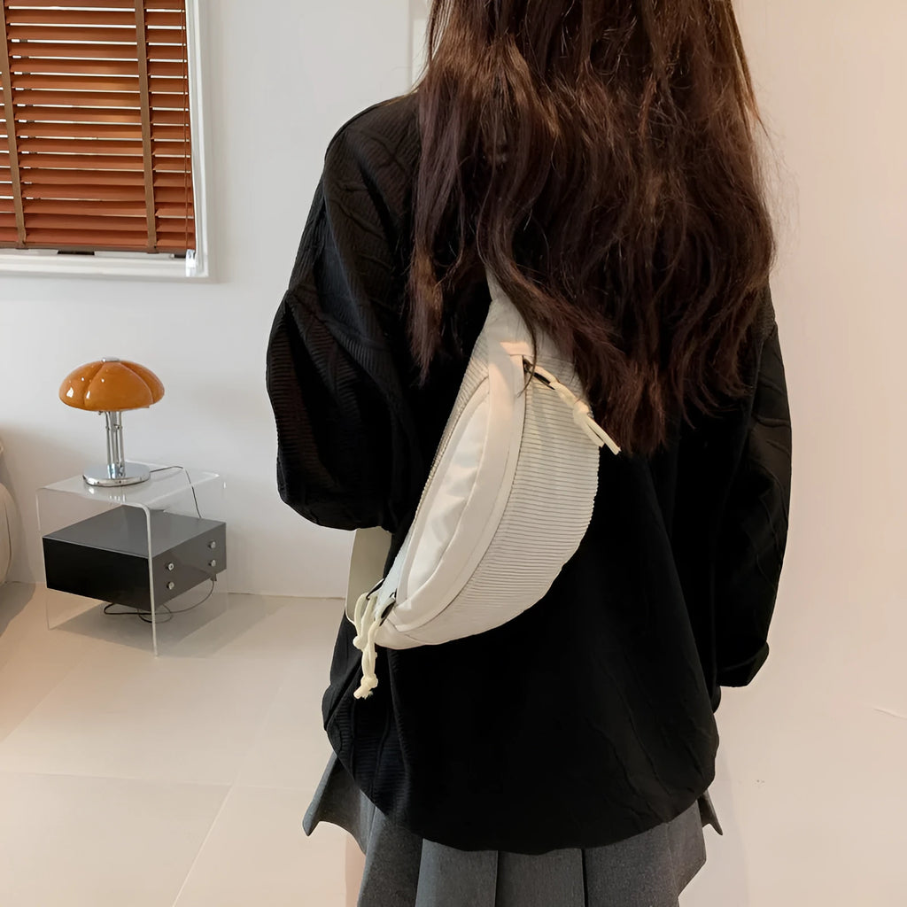 Corduroy crossbody bag in brown with oval shape, slit pocket, and crossbody strap