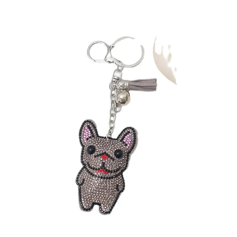 Close-up of a sparkling cartoon dog keychain pendant with rhinestones on an alloy base.