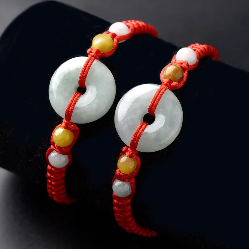 Round emerald jade pendant on adjustable red cord bracelet