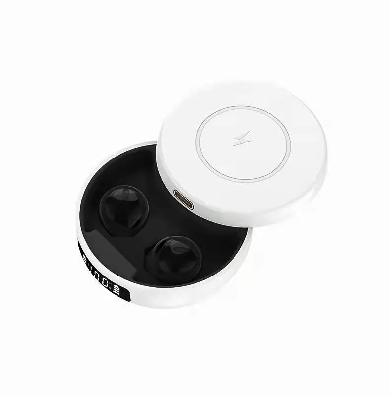 Small black wireless semi-in-ear headphones placed inside their white wireless charging case.