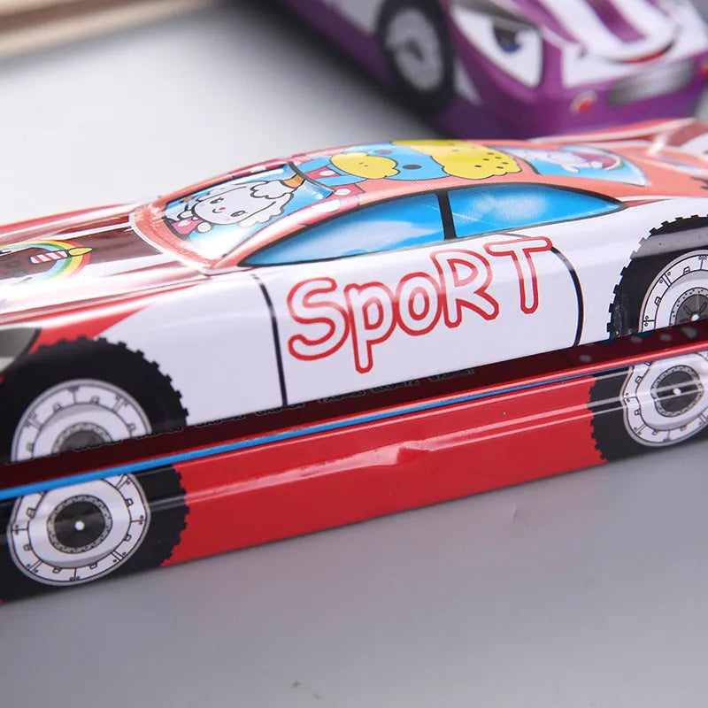 Tinplate car-shaped pencil case with cartoon patterns showing double-layer interior